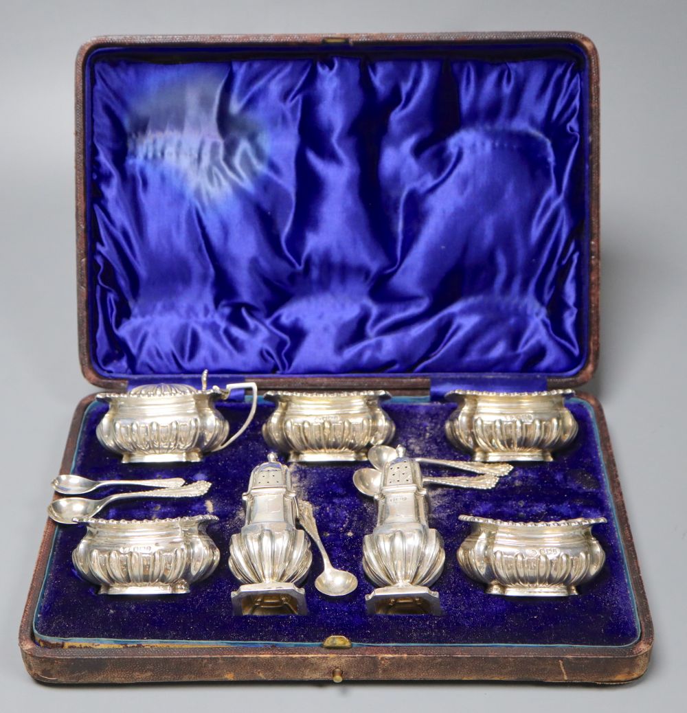 A late Victorian cased silver seven piece condiments set and five spoons (one associated), John Round, Sheffield, 1896.